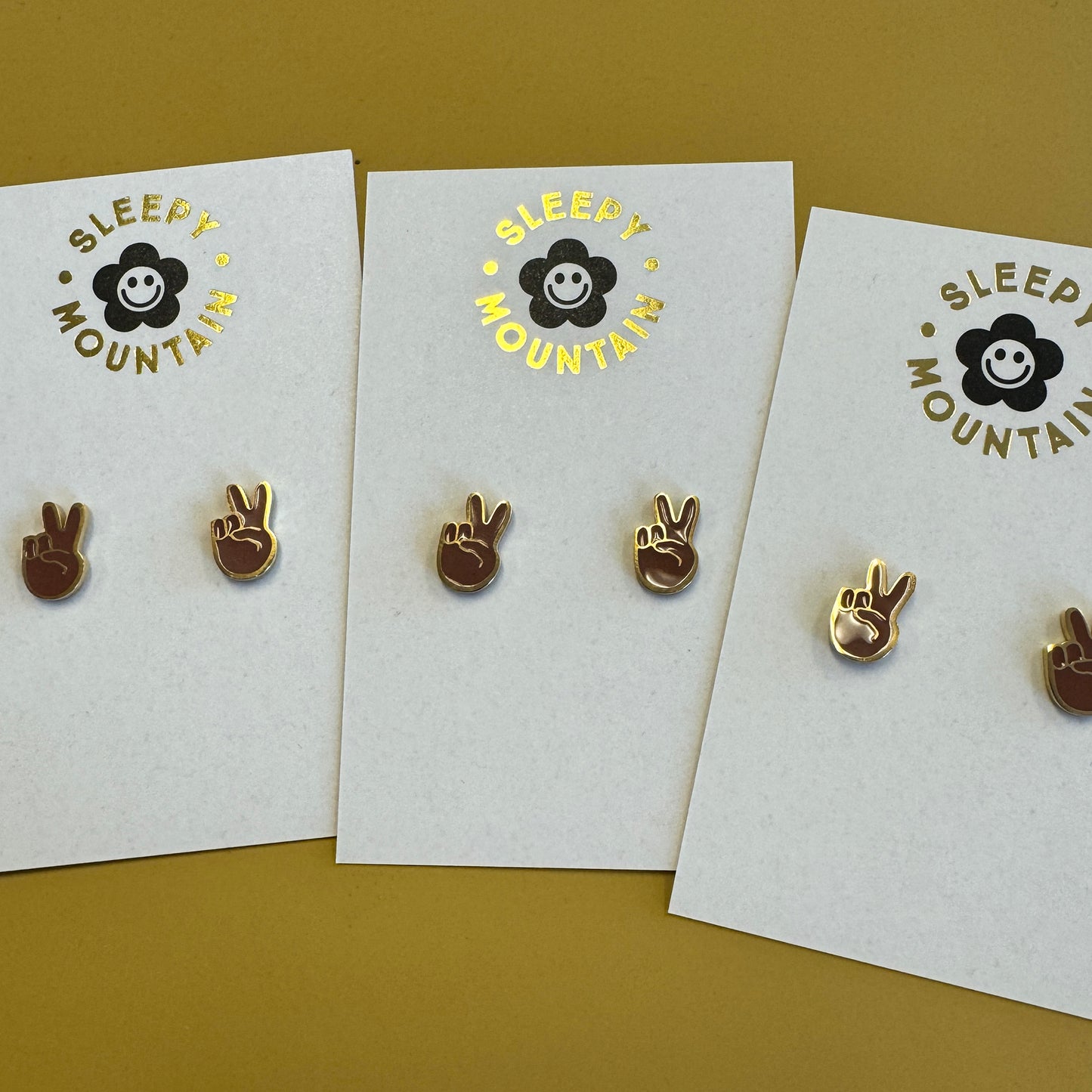 Brown peace hand stud earrings